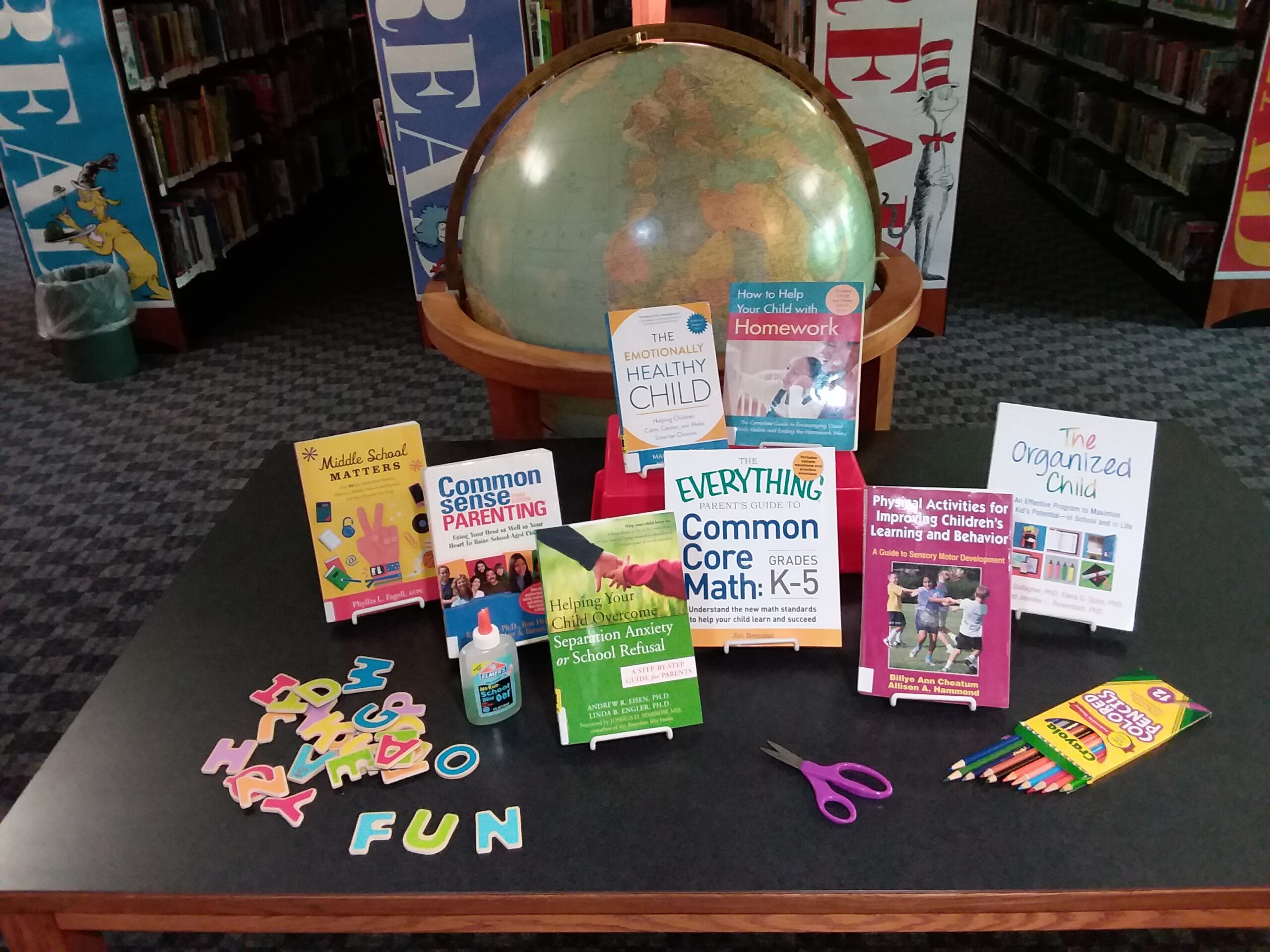 a table with school supplies and related books for parents on it